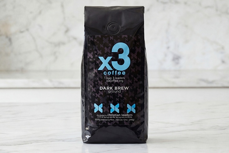 Bag of x3 Coffee Dark Brew ground coffee displayed on a light marble surface.