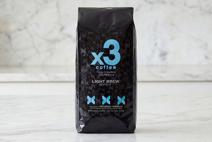Bag of x3 Coffee Light Brew ground coffee displayed on a light marble surface.
