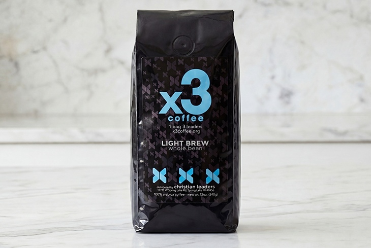Bag of x3 Coffee Light Brew whole bean coffee displayed on a light marble surface.