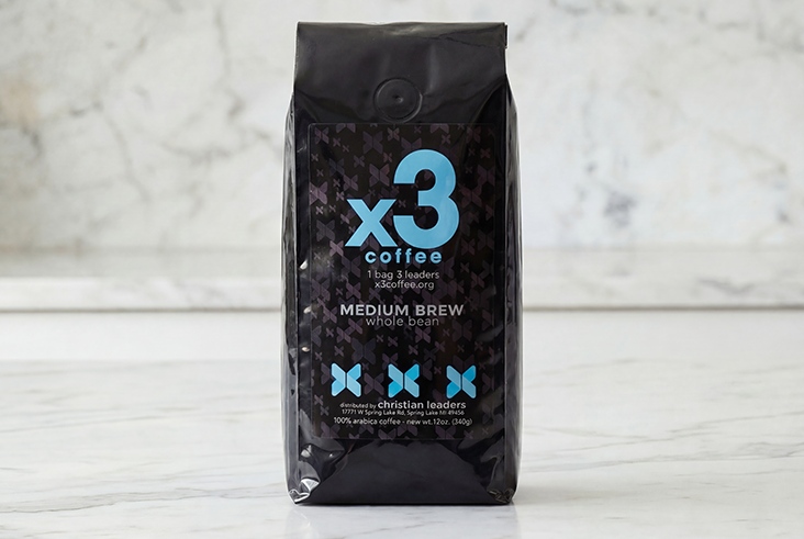 Bag of x3 Coffee Medium Brew whole bean coffee displayed on a light marble surface.